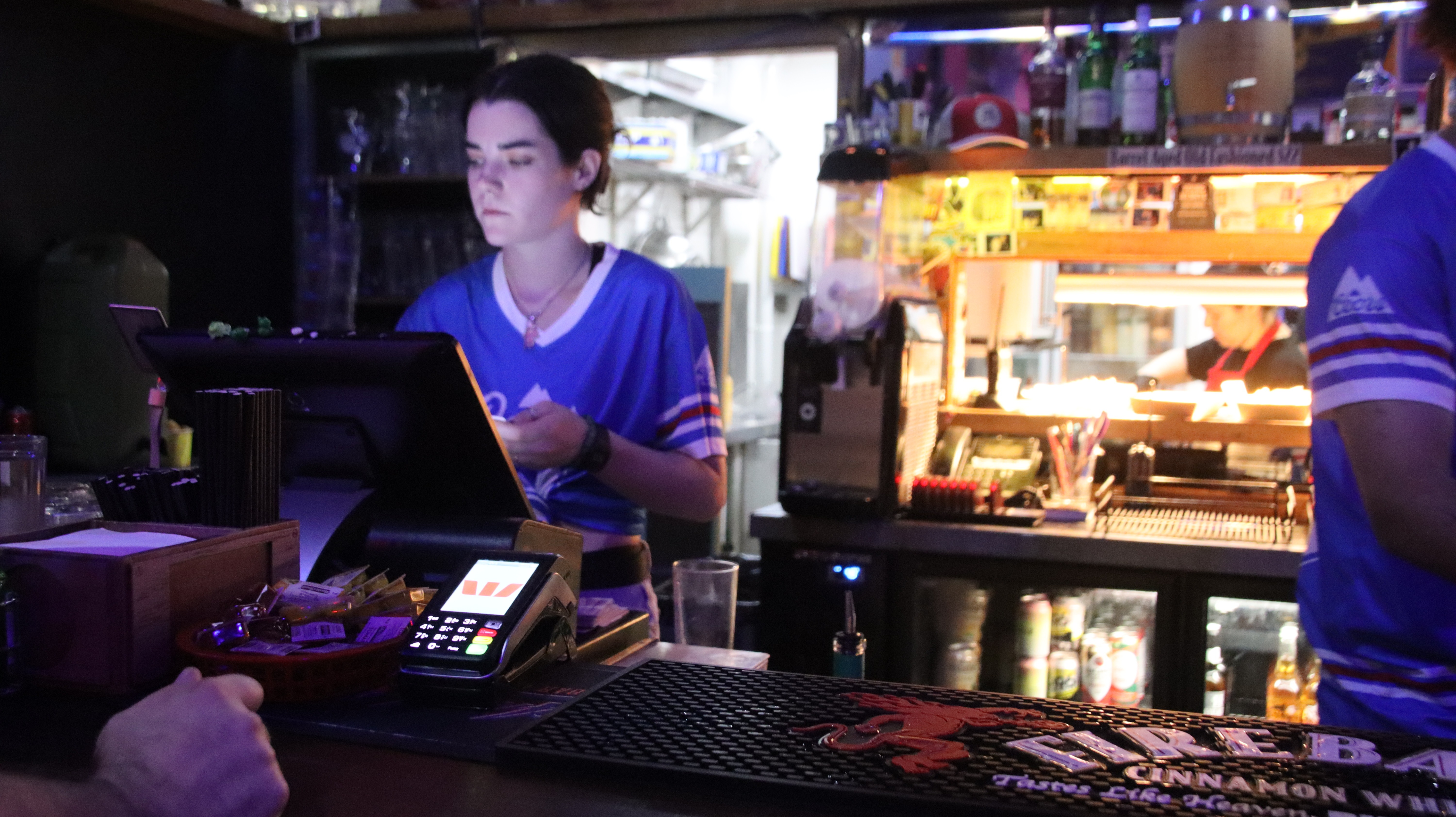 Bartender serving up drinks at the bar