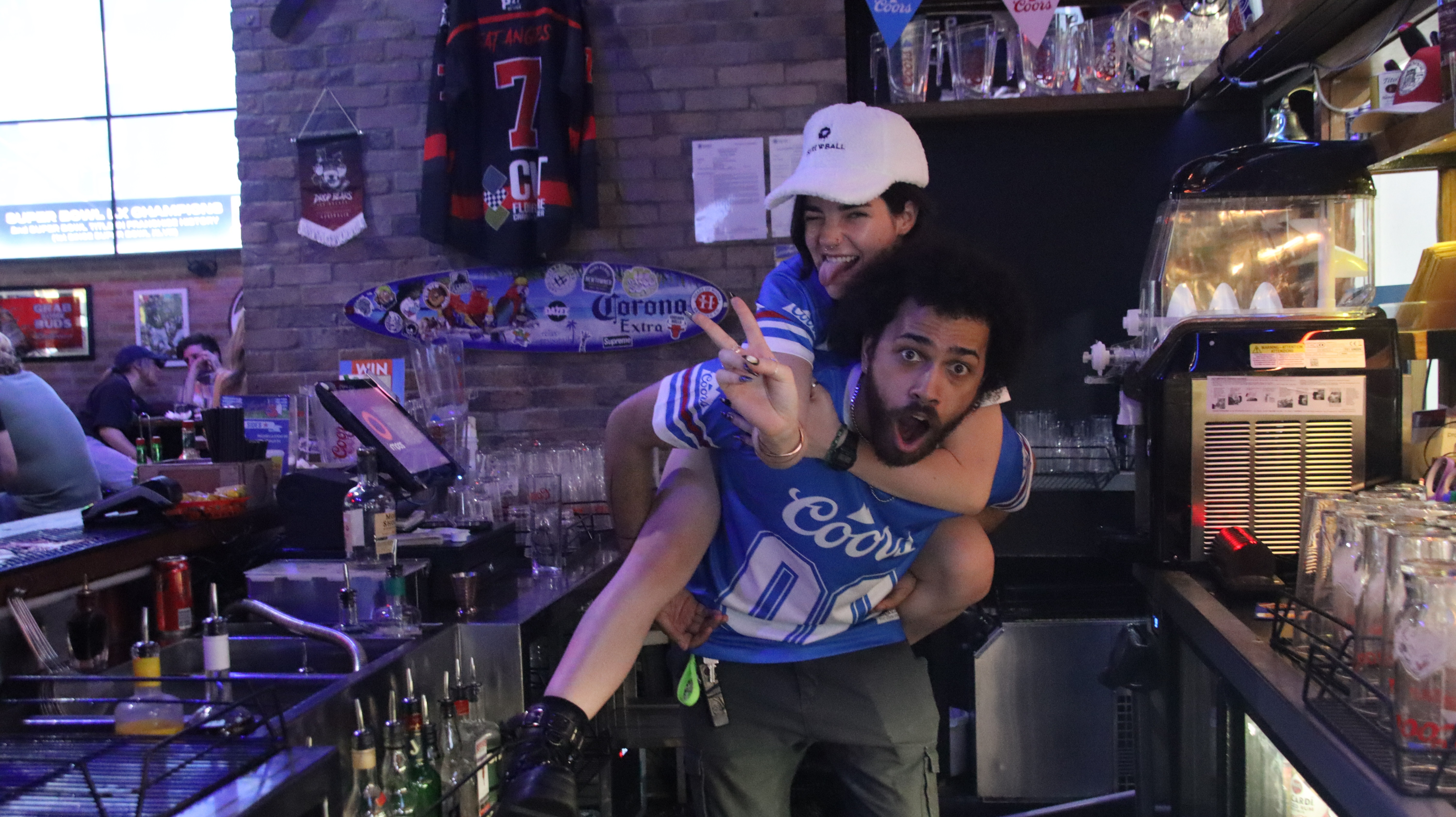 Fat Angel staff mucking around behind the bar